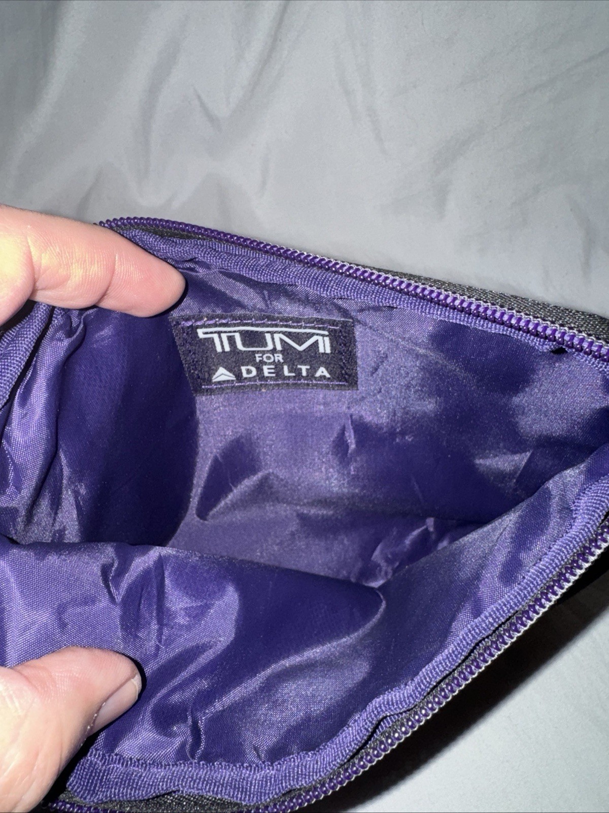 Tumi travel bag black and purple w silver logo zip around toiletry case pouch